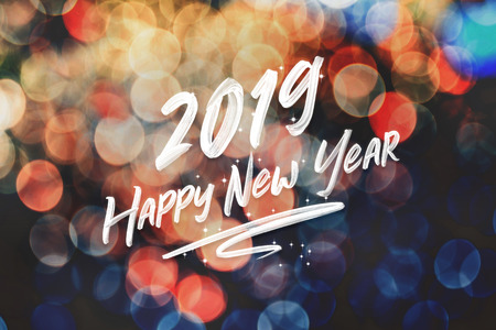 Brush stroke handwriting 2019 happy new year on abstract festive colorful bokeh light background,holiday greeting cardの写真素材