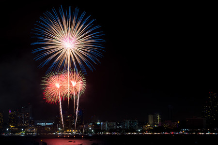 Fireworks explored over cityscape at night in sea port in Pattaya.Holiday festive celebration backgroundの写真素材