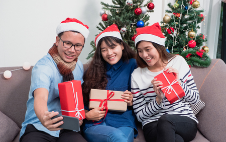 Christmas party with friends, asian woman selfie with smiling face with friends,Holiday celebration conceptの写真素材