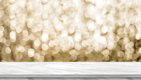 Empty light grey marble glossy table top with blur sparkling gold bokeh abstract background,panoramic banner for display or montage of product,Holiday seasonal concept backdropの写真素材