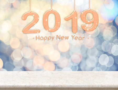 2019 new year peace color (3d rendering) hanging over marble table top with pastel blue and orange sparkling bokeh light,Holiday concept,leave space for adding your contentの写真素材