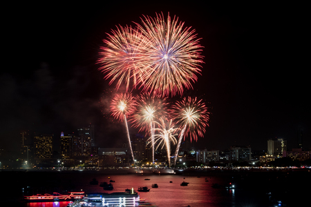 Fireworks explored over cityscape at night in sea port in Pattaya.Holiday festive celebration backgroundの写真素材