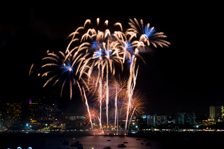 Fireworks explored over cityscape at night in sea port in Pattaya.Holiday festive celebration backgroundの写真素材