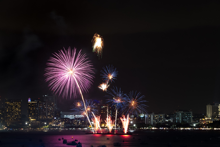 Fireworks explored over cityscape at night in sea port in Pattaya.Holiday festive celebration backgroundの写真素材
