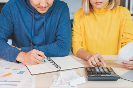 Close up Asian couple list home financial bill budget on table in kitchen at new houseの素材 [FY310112241493]