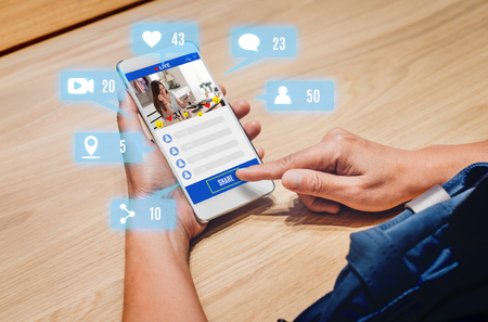 woman share view of beauty blogger review online with mobile apps on wood table at home,online influencer technology in daily lifestyle,Digital age conceptの写真素材