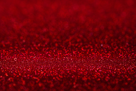 Abstract vivid red sparkling glitter wall and floor perspective background studio with blur bokeh.luxury holiday backdrop mock up for display of product.holiday festive greeting cardの写真素材
