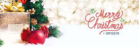 Red Merry Christmas and happy new year handwriting with xmas tree and gift box at blur bokeh light background,Winter holiday banner greeting cardの写真素材