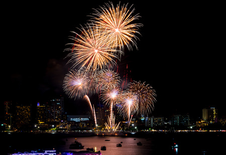 Fireworks explored over cityscape at night in sea port in Pattaya.Holiday festive celebration backgroundの写真素材