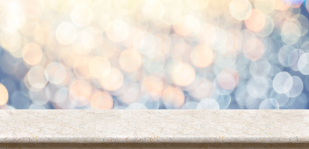 Empty marble glossy table top with blur sparkling soft pastel blue and orange bokeh abstract background,panoramic banner for display or montage of product,Holiday seasonal concept backdropの写真素材