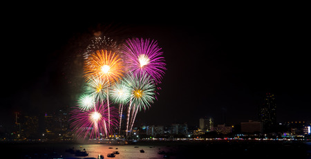 Fireworks explored over cityscape at night in sea port in Pattaya.Holiday festive celebration backgroundの写真素材