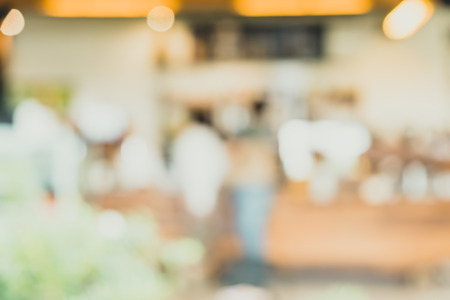 Blurred background people order beverage at counter bar in Coffee shop blur background with bokeh light.leisure lifestyle backdropの写真素材