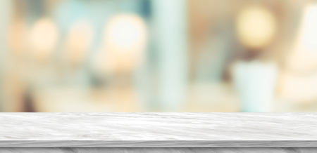 Empty white marble table and blurred soft light table in luxury restaurant with bokeh background. product display template.Business presentationの写真素材
