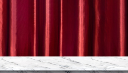 Empty white marble table and blurred vivid red luxury curtain background. product display template.Business presentationのイラスト素材