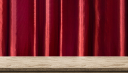Empty wood table and blurred vivid red luxury curtain background. product display template.Business presentationの写真素材