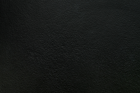 Black rough concrete wall texture backgroundの写真素材