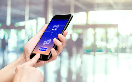 Hand holding mobile with pay word and bill icon feature with blur back office counter background,Digital Lifestyle conceptの写真素材