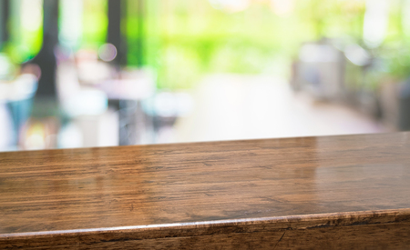 Empty perspective hardwood table with blur kitchen in garden background bokeh light,Mock up for display or montage of product,Banner or header for advertise on online mediaの写真素材