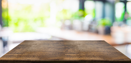 Empty perspective hard wood table and blurred garden cafe light background. product display template.Business presentationの写真素材