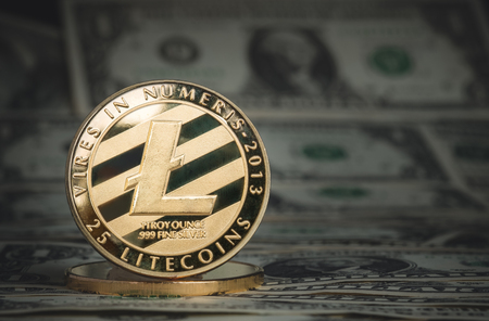 crypto currency gold litecoin on dollar banknote background.Virtual digital money concept.financial business.の写真素材