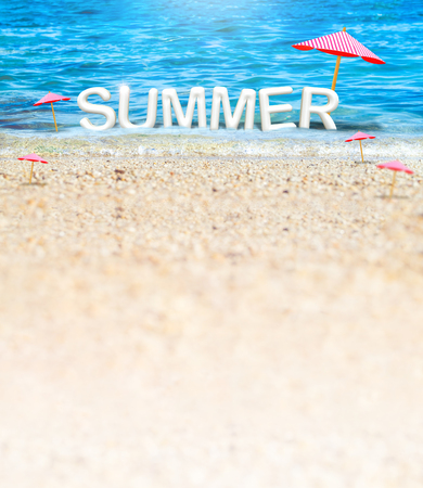 Summer (3D Rendering text) white word with beach umbrella on sand beach and blue sea blur background,Summer Vacation banner concept.の写真素材