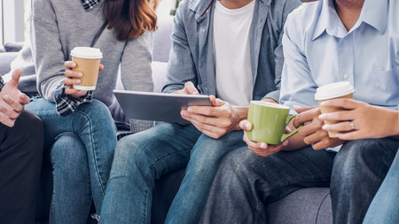 Close up Creative office,Designer team use tablet in casual meeting at sofa and got a good idea for...