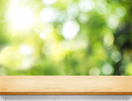 Empty wood plank table top with blur tree in park with bokeh light at background,Mock up template for display of your design,Banner for advertise of productの写真素材