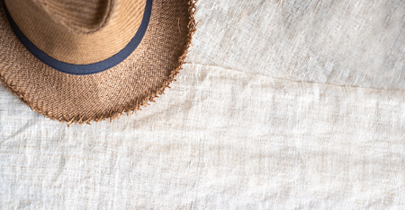 Top view of Summer brown panama straw hat on linen cloth.travel concept.copy space for adding text.の写真素材