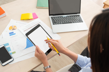 top view woman use tablet and laptop working online on table at home.mock up template device screen.Digital lifestyle concept.clipping path screenの写真素材