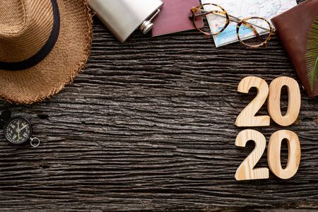 top view 2020 happy new year number on wood table with adventure accessory item,holiday vacation planningの写真素材