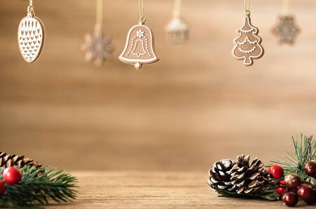 Christmas decoration on wood table with copy space.pine cone,mistletoe and bell ball hanging with blur wood wall background.Holiday greeting card.の写真素材