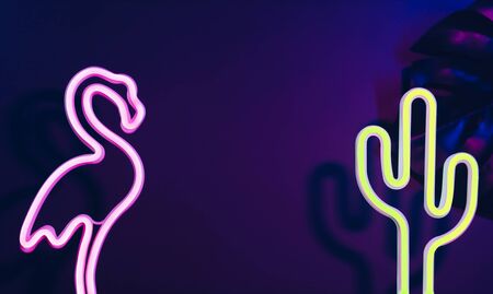 Summer time with pink flamingo, cactus and monstera leaf with neon pink and blue light.Vacation banner mock up space for adding textの写真素材
