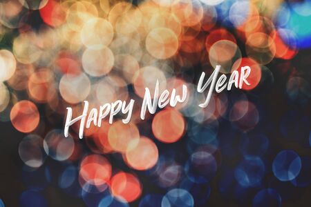 Happy new year font at colorful bokeh light background.holiday celebration greeting cardの写真素材