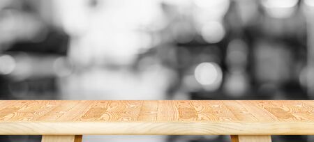 Empty wood table top with blurred black and white cafe background. Mock up for display or montage of product,Business banner presentation.の写真素材