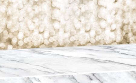 white marble glossy table diagonal with blur sparkling gold bokeh abstract background,panoramic banner for display or montage of product,Holiday seasonal concept backdropの写真素材