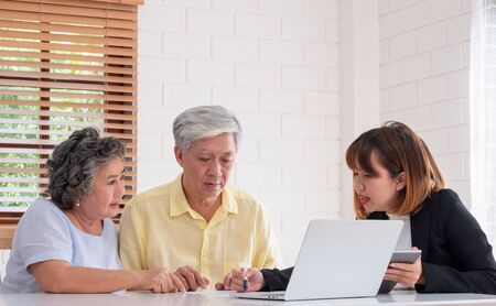 senior couple get advice from financial planner at home.aging at homeの写真素材