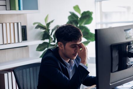 businessman get stress while working at office,headache about job.eye hurt from computer screenの写真素材