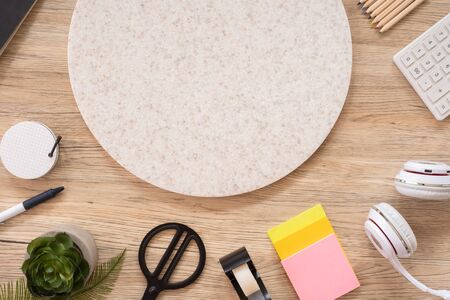 office table desk top view with stationery, notebook,headphone,plant,noteapd and caculator on wooden table flat lay background with copy space. education stuff.craft creator leisure lifestyle backdropの写真素材
