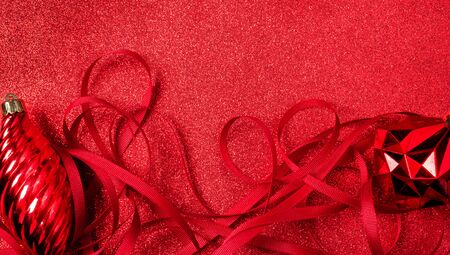 Christmas and happy new year red background.top view of ribbon  decoration ball on sparkling table.holiday celebration greeting card.copy sapce mockup for display of designの写真素材