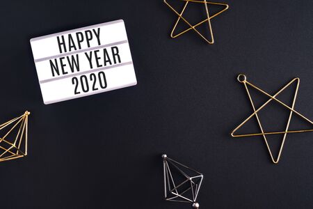 happy new year 2020 party light box with star decoration holiday festive item top view on black background table with copy space.celebration new year eve conceptの写真素材