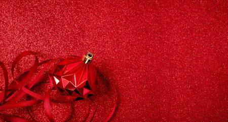 Christmas and happy new year red background.top view of ribbon  decoration ball on sparkling table.holiday celebration greeting card.copy sapce mockup for display of designの写真素材