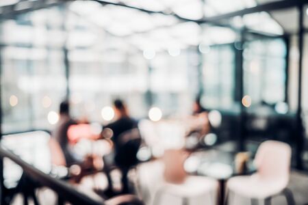 Blurred background of customer sitting in coffee shop or cafe restaurant with bokeh light.の写真素材