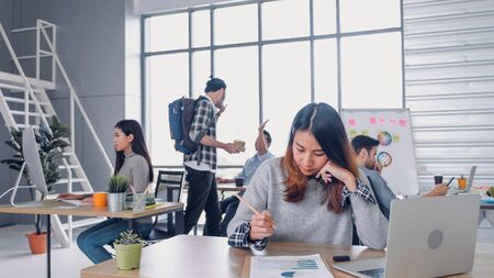 Group of diversity creative designer working at modern office building.casual office lifestyle with technology.woman designer writing plan on paperの写真素材