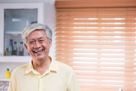 Asian senior man smile in living room at home,Happy aging at home concept.の写真素材