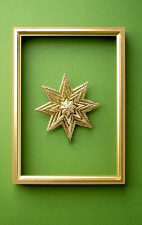 Sparking snowflex christmas with golden frame in green luxury background. holiday celebration greeting card. banner panoramic mockup for display of designの写真素材