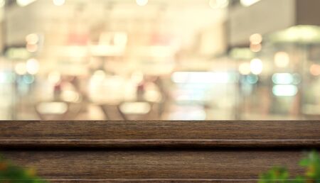 Empty step dark wood table top food stand with blur people in coffee shop background bokeh light. Mock up for display or montage of product, Banner for advertise on online media, business presentationの写真素材