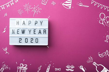 happy new year 2020 light box with doodle party item decoration holiday festive item top view on...