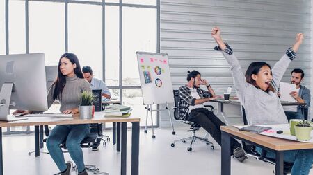 group of creative designer dancing in office with relax feeling and glad about good success news of project at modern office.business day work lifestyleの写真素材