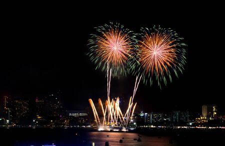 Happy new year fireworks over cityscape at night.holiday celebration festivalの写真素材