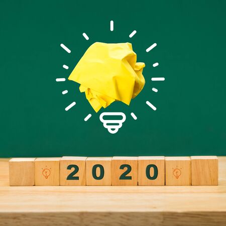 trends 2020 idea on wood cube block on table with green blackboard.business forecasting conceptの写真素材